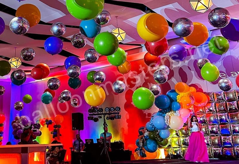 Dance-Floor-3 silver and rainbow assorted balloons individually hung from ceiling above dance floor.